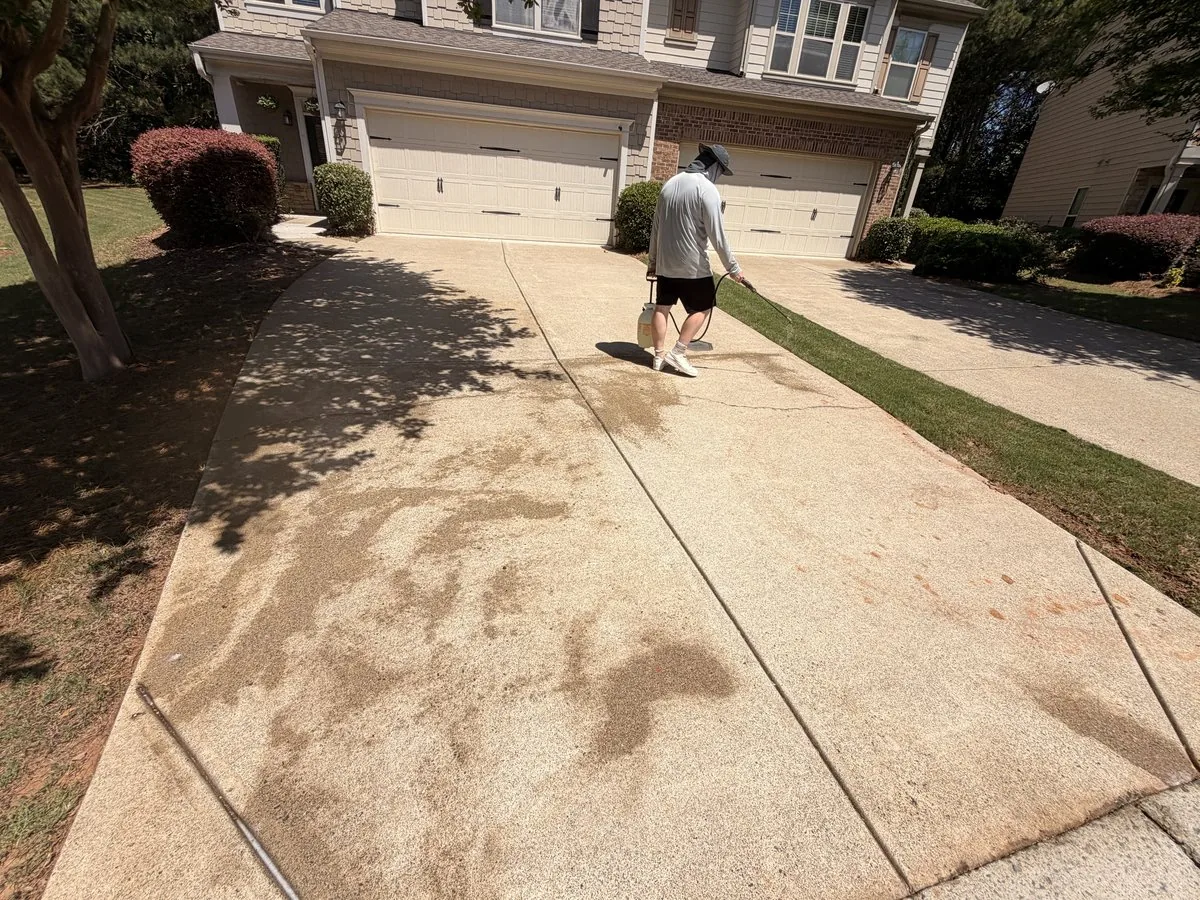 Tech pressure washing driveway in progress